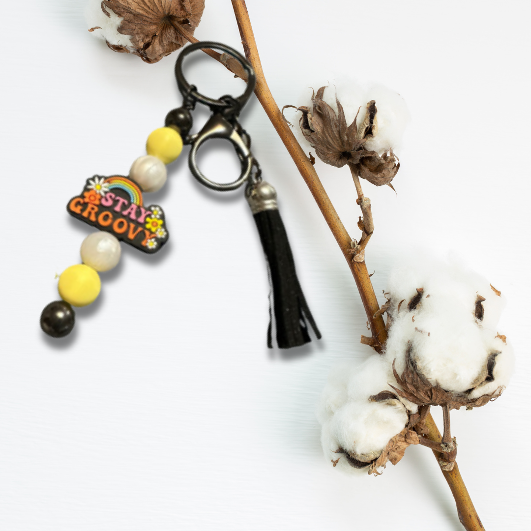 A fun and colorful accessory that brings positive vibes to your everyday essentials. Add a touch of joy and nostalgia to your keys or bag with this lively keychain.