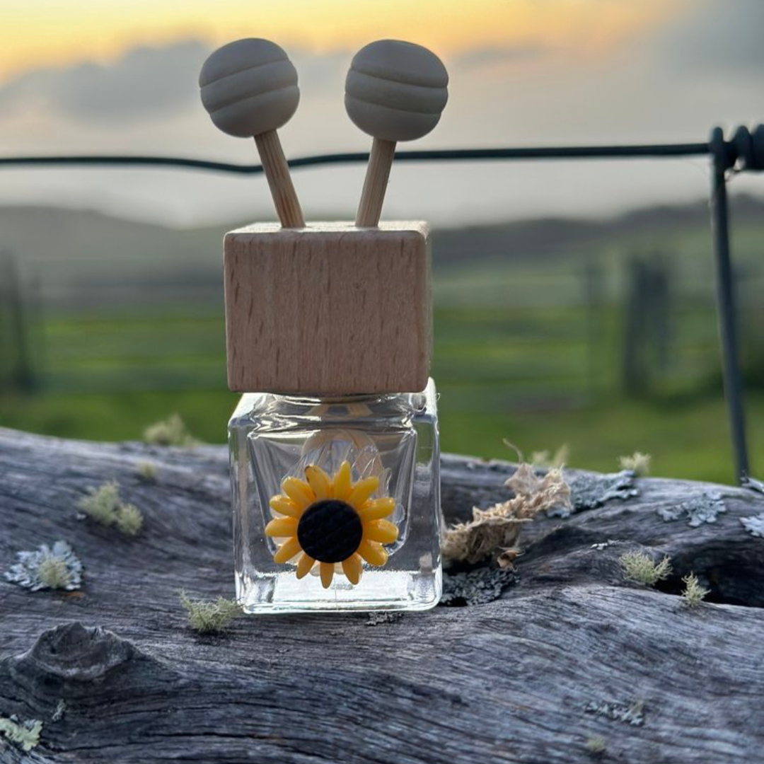 Sunflower car diffuser with essential oils, sunflower-themed car air freshener in use, stylish sunflower diffuser for cars