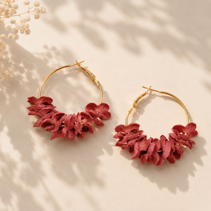 Rose floral hoop earrings on a beige background