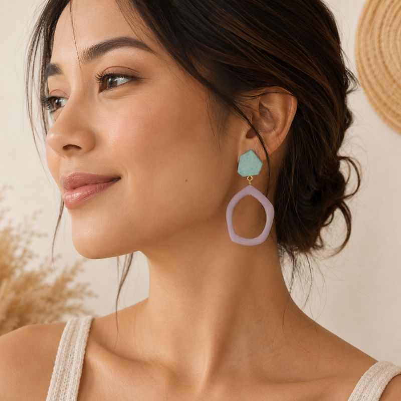 Woman wearing colorful earrings with a neutral background-Designs by Berniemae