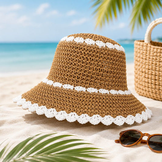 Brown straw hat with white trim on a sandy beach with sunglasses and a bag.-Designs by Berniemae