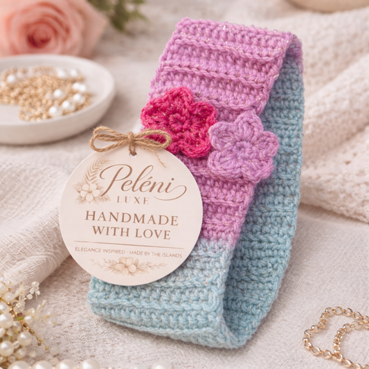 Crocheted headband with flowers and a 'Peleni Luxe' label on a soft background