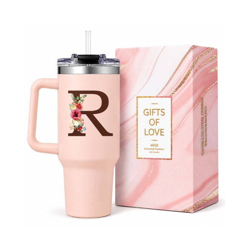 Pink tumbler with letter 'R' and floral design next to a pink gift box with 'Gifts of Love' text.