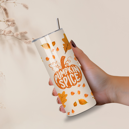 Hand holding a pumpkin spice-themed tumbler with leaf designs on a neutral background