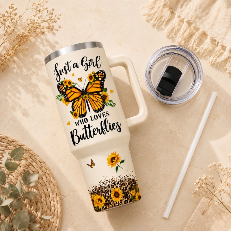 White tumbler with butterfly design and text on a beige surface