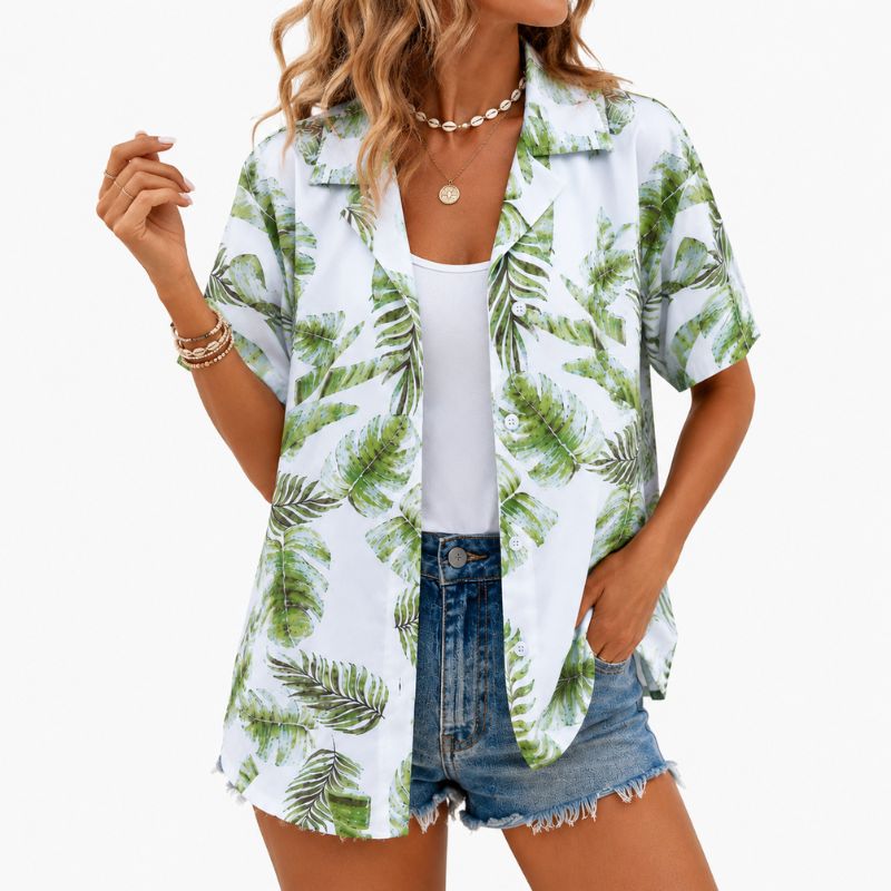 Woman wearing a tropical leaf print shirt over a white top and denim shorts on a white background-Designs by Berniemae