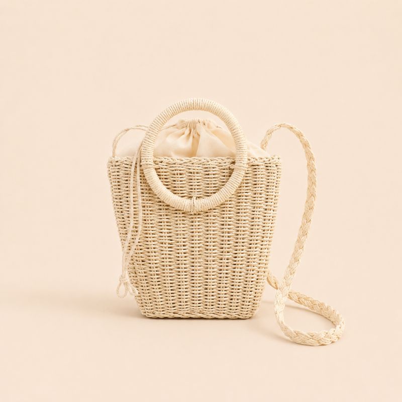 Woven handbag with a strap on a beige background